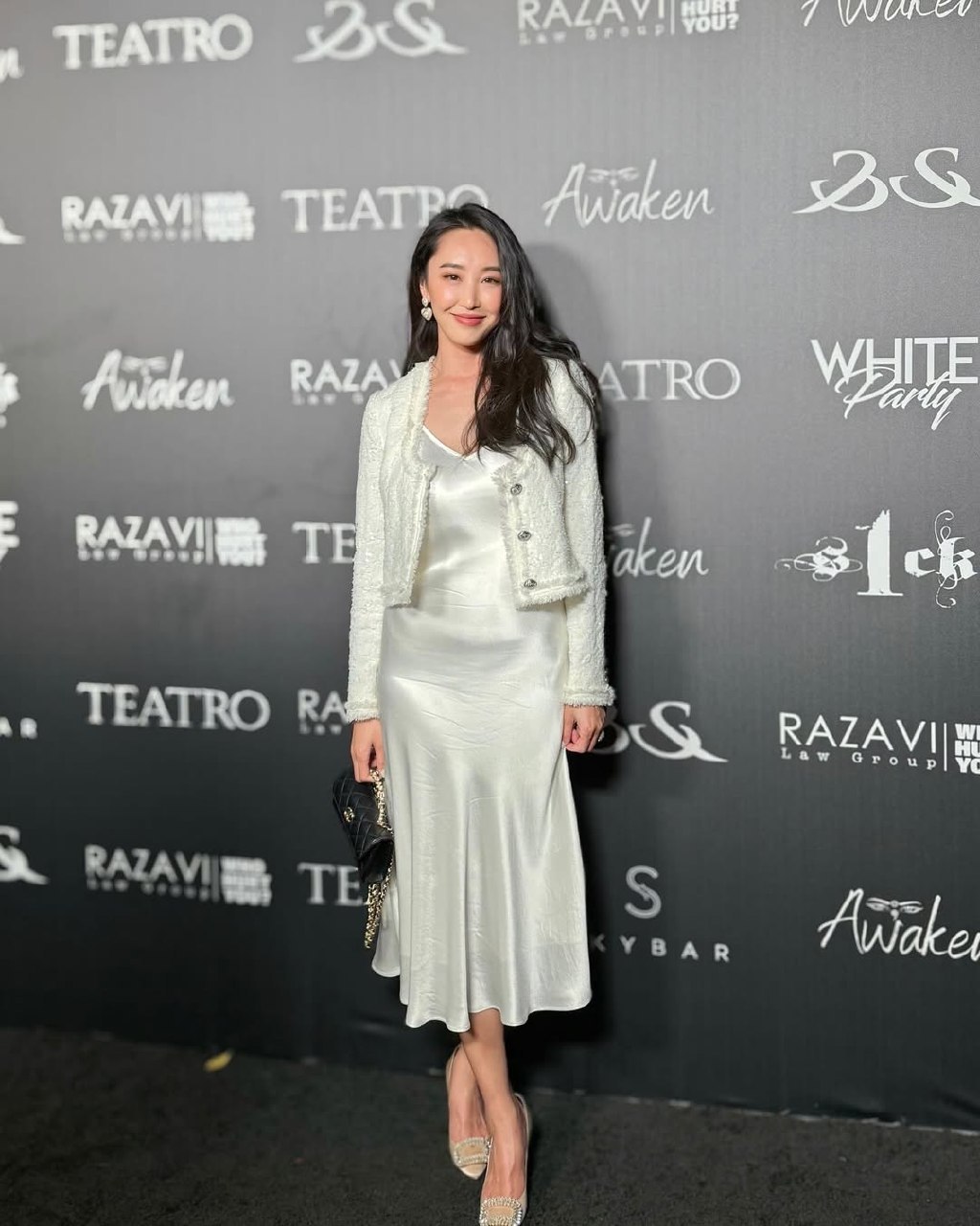 Event-style photo showing an individual posing in front of a backdrop